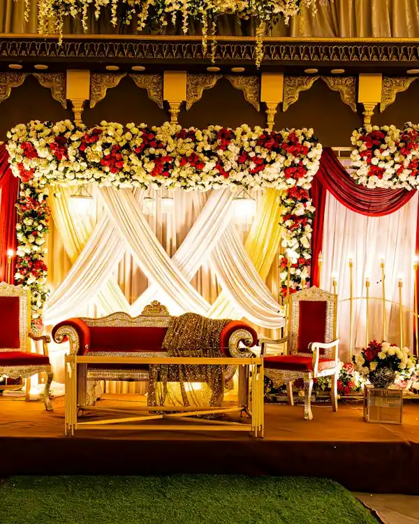 Decorated wedding stage with flowers and drapes